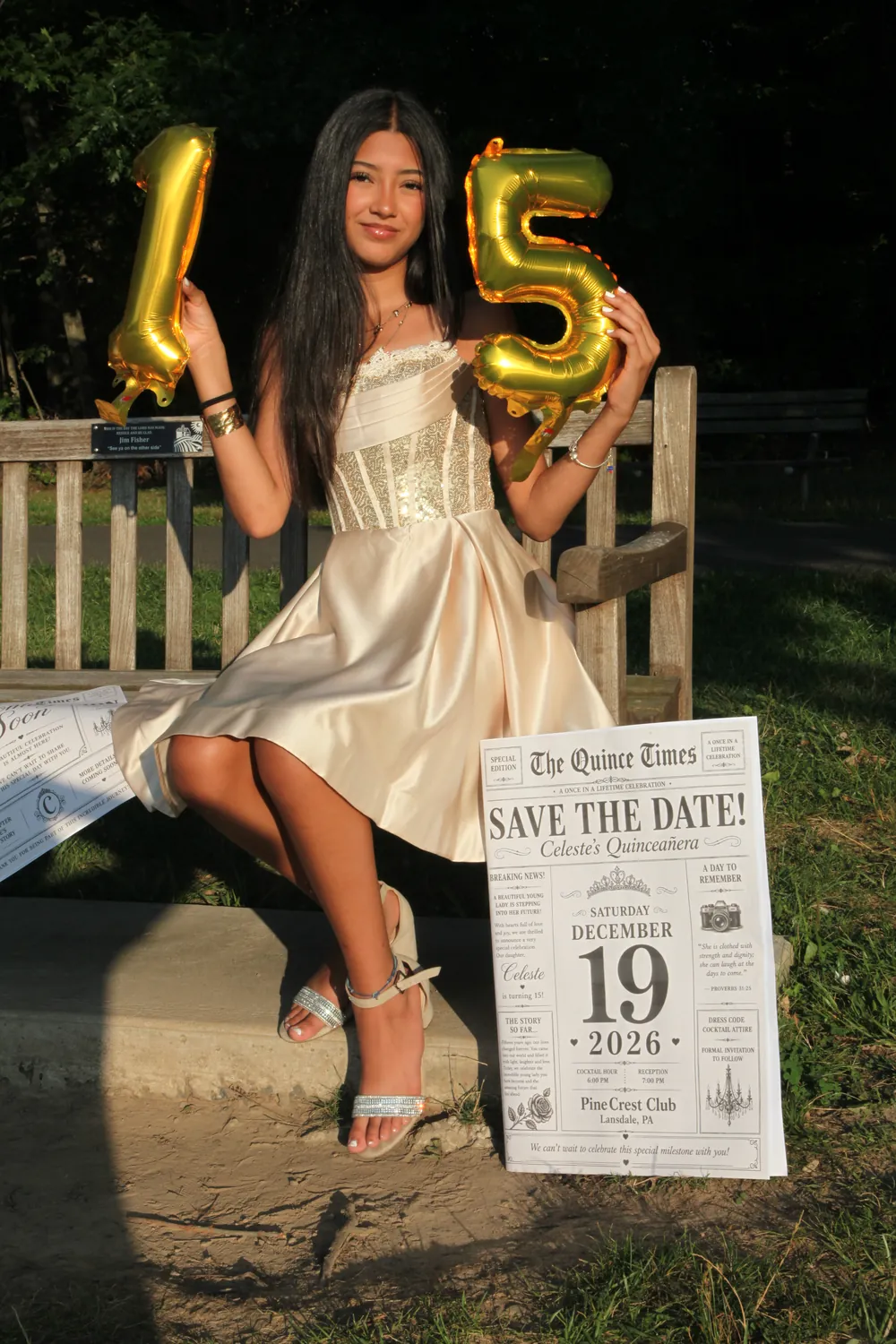 Celeste holding up the gold balloons shaped like 1 and 5.