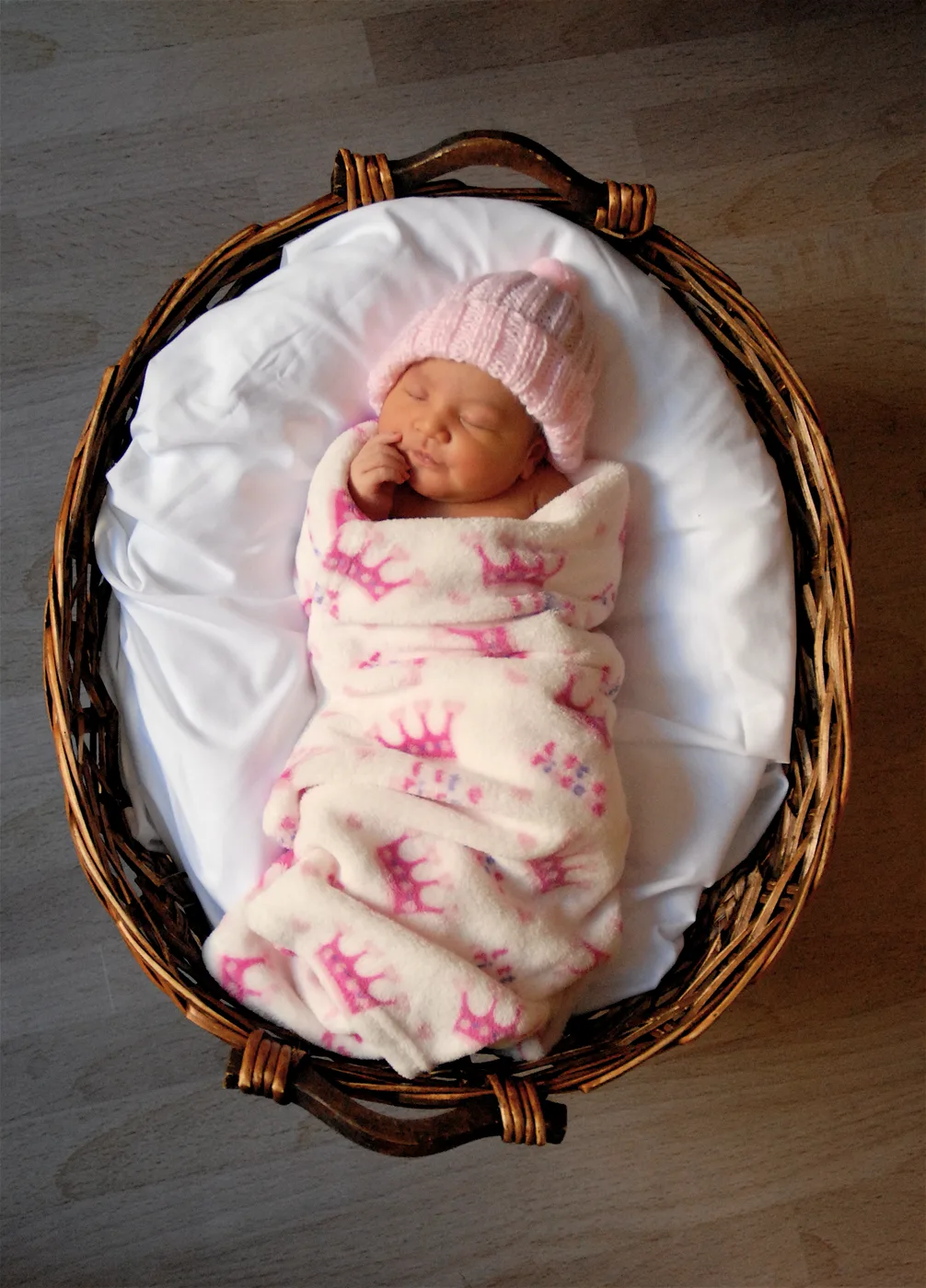 Celeste as a newborn, asleep in a basket.