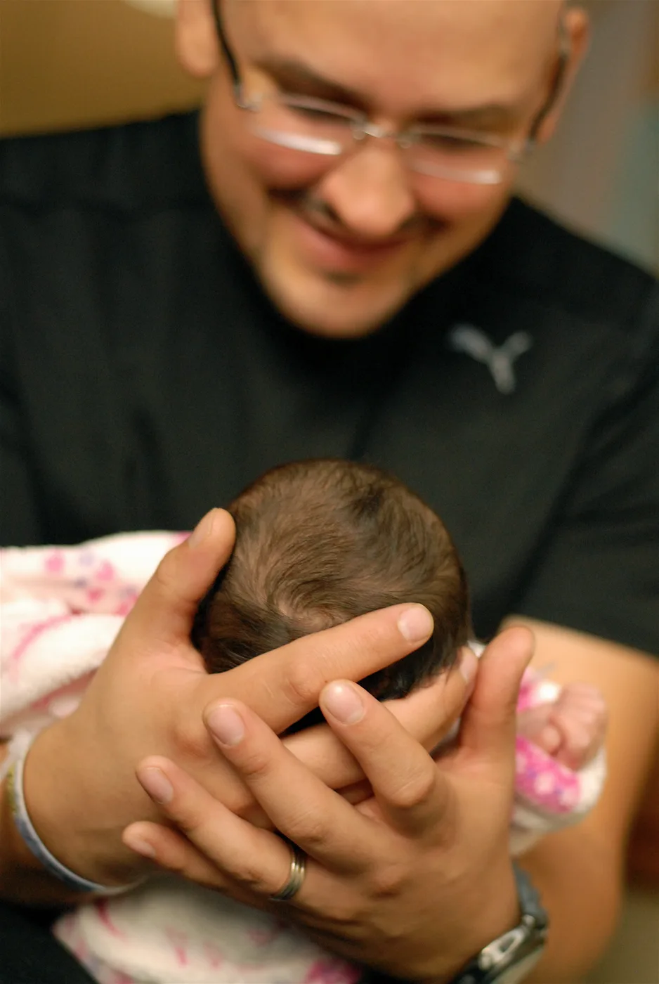 Her dad holding newborn Celeste.