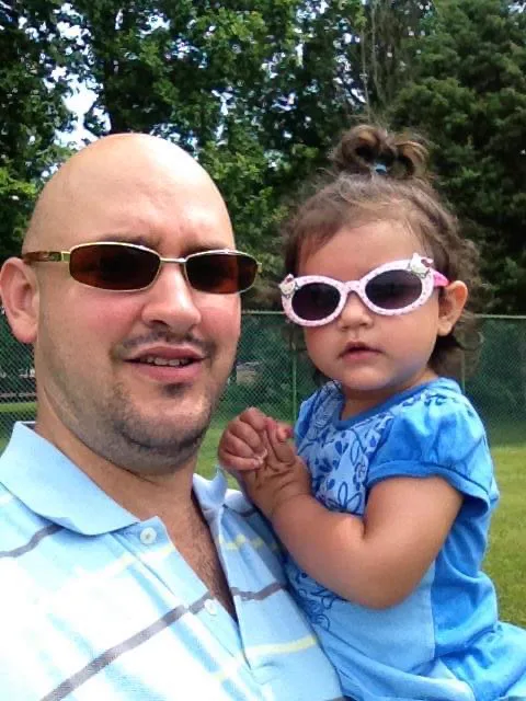 Little Celeste and her dad, both in sunglasses.