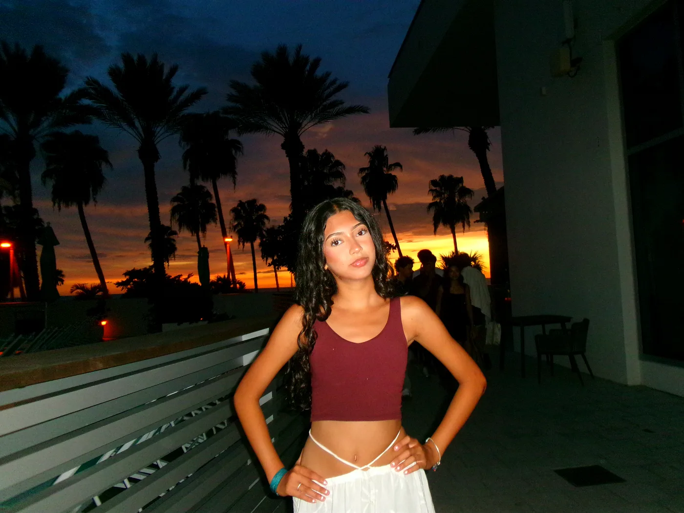 Celeste at dusk under the palm trees.
