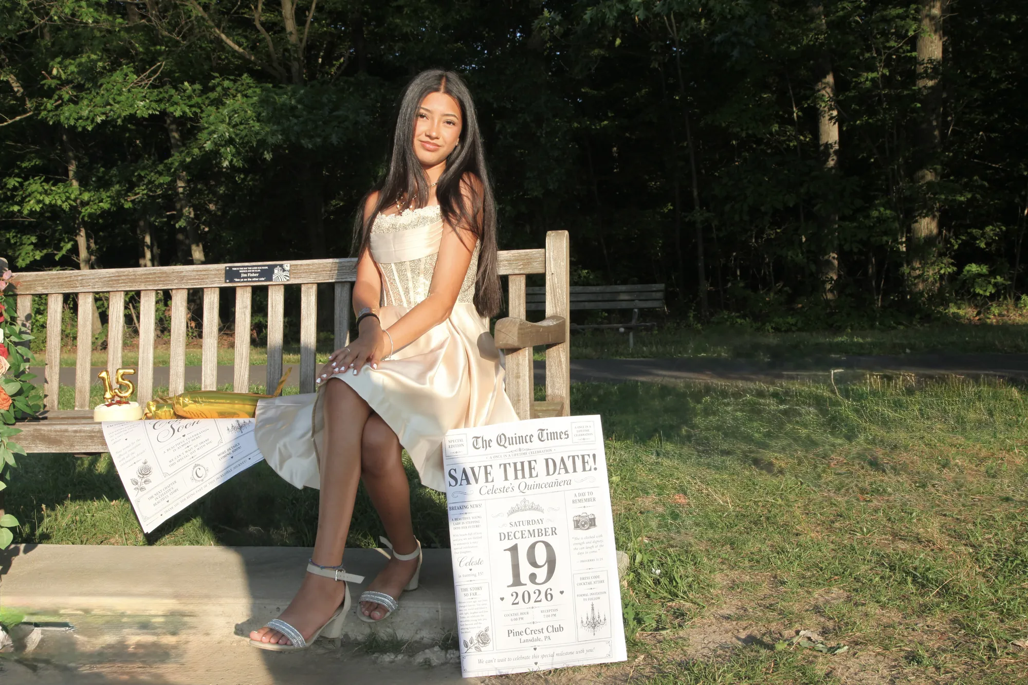 Celeste sitting on a wooden bench at sunset, beside the Save the Date newspaper and the gold 15 balloons.